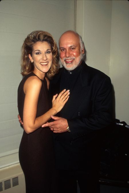 Celine Dion in a black dress poses with her husband Rene Angelil